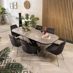 a dining room table surrounded by chairs and plants