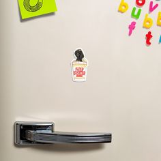 a refrigerator with magnets on the door and stickers attached to it