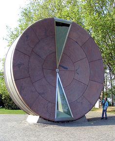 a person standing in front of a large object that looks like it has been cut open