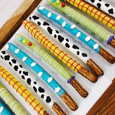 several colorful toothbrushes are lined up in a row on a table with white paper