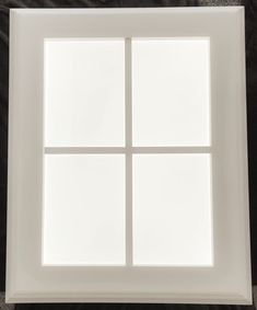 a white square window sitting on top of a wall