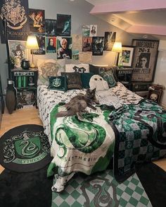 a harry potter themed bedroom with hogwarts bedding and posters on the wall