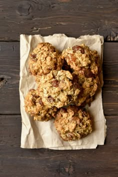 some oatmeal cookies are sitting on top of a piece of parchment paper