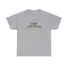 a grey t - shirt with the words camp firewood printed in brown on it