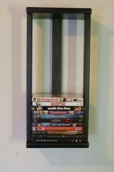 there is a shelf with several movies on it