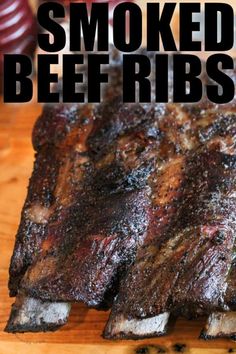 there is a large piece of meat on the cutting board that says smoked beef ribs