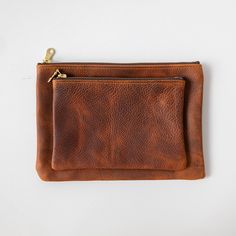 The zip pouch is handmade of beautiful full-grain leather, with a solid brass zipper that features a big and beautiful "donut" pull. It's the perfect accessory to organize items in your tote or to carry on its own. The small zip pouch measures 5.5 inches by 7.5 inches, and the medium zip pouch measures 7 inches by 9.5 inches. Leather Zipper Pouch, Leather Zip Pouch, Zipper Pouches, Leather Clutch Bag, Mini Pouches, Mini Tote Bag, Petrol Blue, Leather Clutch Bags, Small Pouches