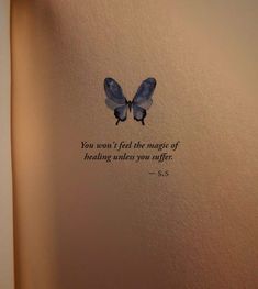 an open book with a blue butterfly on the pages and a quote written in it