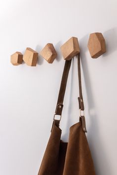 a brown bag hanging on the wall next to some wooden cubes and pieces of wood