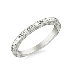 a wedding band with intricate engraving on it