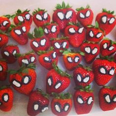 a bunch of strawberries with faces painted on them