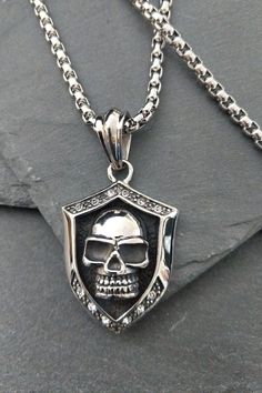 "Men's Gothic Skull Shield Necklace, Silver Stainless Steel Biker Punk CZ Crystal Skull Pendant Necklace, CHRISTMAS GIFT Stunning chunky statement bespoke gift, a bold Gothic-inspired, biker punk pendant necklace featuring an etched-out polished skull against the blackened hammered background. Encased in a large shield with encrusted cubic zirconia clear crystals.  Beautifully crafted with detail, the back has been left unpolished to get a feel for the authentic crafting.     PERFECT FOR ALL OCC Shield Necklace, Celtic Necklace, Gothic Skull, Bespoke Gifts, Crystal Skull, Clear Crystals, Chains For Men