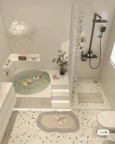 a bathroom with a bathtub, shower head and rug on the floor in front of it