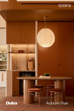 an image of a modern kitchen setting with lights on the ceiling and chairs around the table