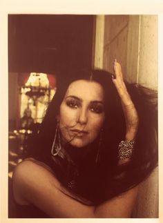 a woman with long hair and piercings posing for the camera