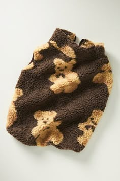 a brown teddy bear blanket laying on top of a white table