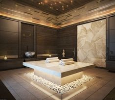 a spa room with stone flooring and lights