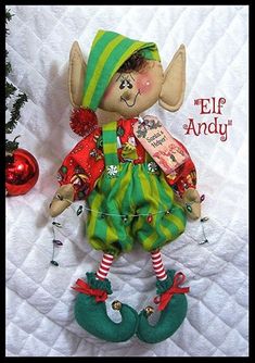 a christmas card with an elf doll on it