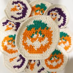 crocheted pumpkin coasters on top of each other