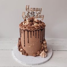 a birthday cake with chocolate icing and decorations