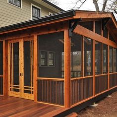 a house with wooden deck and screened porch