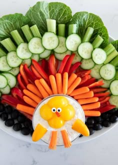 a platter with carrots, celery, cucumbers and other vegetables