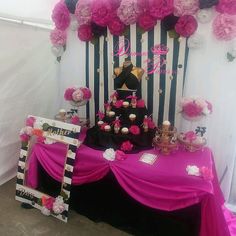 the table is decorated with pink and black decorations