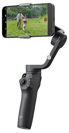 a cell phone is attached to a tripod with a video game controller in front of it