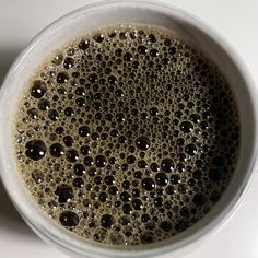 a cup filled with liquid sitting on top of a table