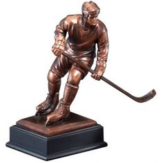 a bronze statue of a hockey player with a stick