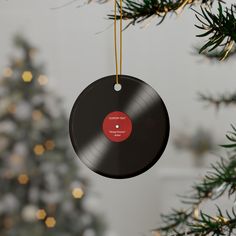 a christmas ornament hanging from a tree with a record on it's side