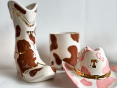 two white and pink cowboy boots sitting next to each other on top of a table