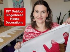 a woman holding up a piece of paper with the words diy outdoor gingerbread house decorations