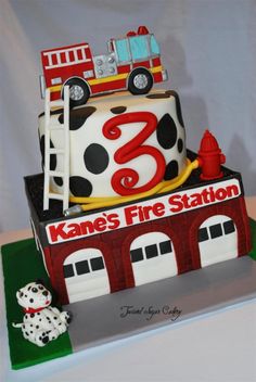 a cake that is shaped like a fire station with a dalmatian on top