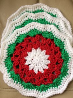 three crocheted coasters sitting on top of a couch