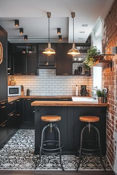 a kitchen with two stools in front of an island and brick wall behind it