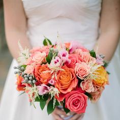 a bride holding a bouquet of flowers in her hands