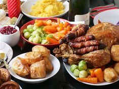 a table full of food including turkey, cranberry sauce and other foods on plates