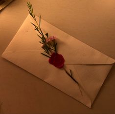 a piece of paper with some flowers on it and a red wax stick sticking out of it