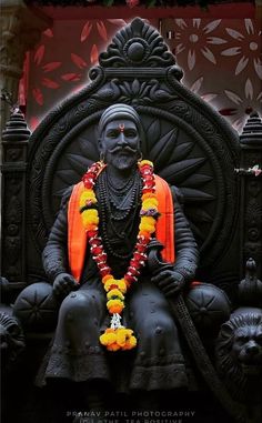 the statue is decorated with flowers and garlands