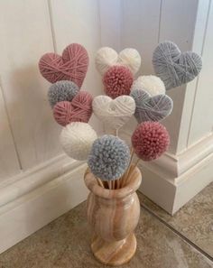 some balls of yarn are in a vase