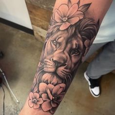 a lion with flowers on his arm