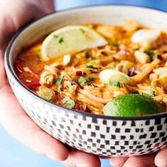 a person holding a bowl of food in their hands