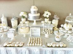 a table topped with lots of desserts and cupcakes