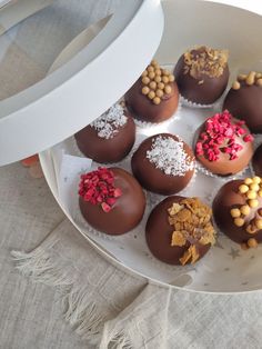 chocolates with sprinkles and nuts in a white bowl