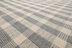 a gray and white checkered rug on the floor