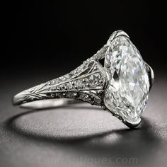 an old - fashioned diamond engagement ring with filigrees