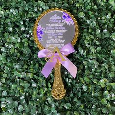 a plaque with a ribbon around it on top of some bushes