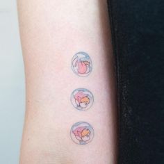 three stickers on the arm of a woman