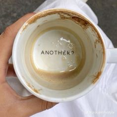 a person holding a coffee cup with the word another written on it